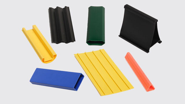 Assorted extruded plastic profiles in yellow, black, green, blue and orange
