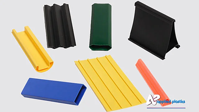 Assorted extruded plastic profiles in yellow, black, green, blue and orange