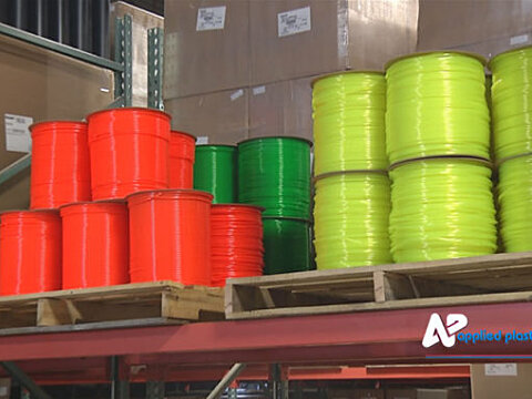Coils of extruded tubing stacked on pallets in the warehouse