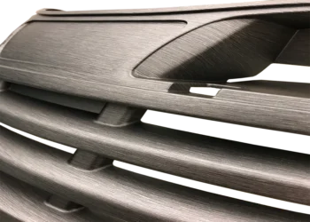 Prototype sample of a brushed aluminum hydrographic finish on the front grille of a lawn tractor / riding mower